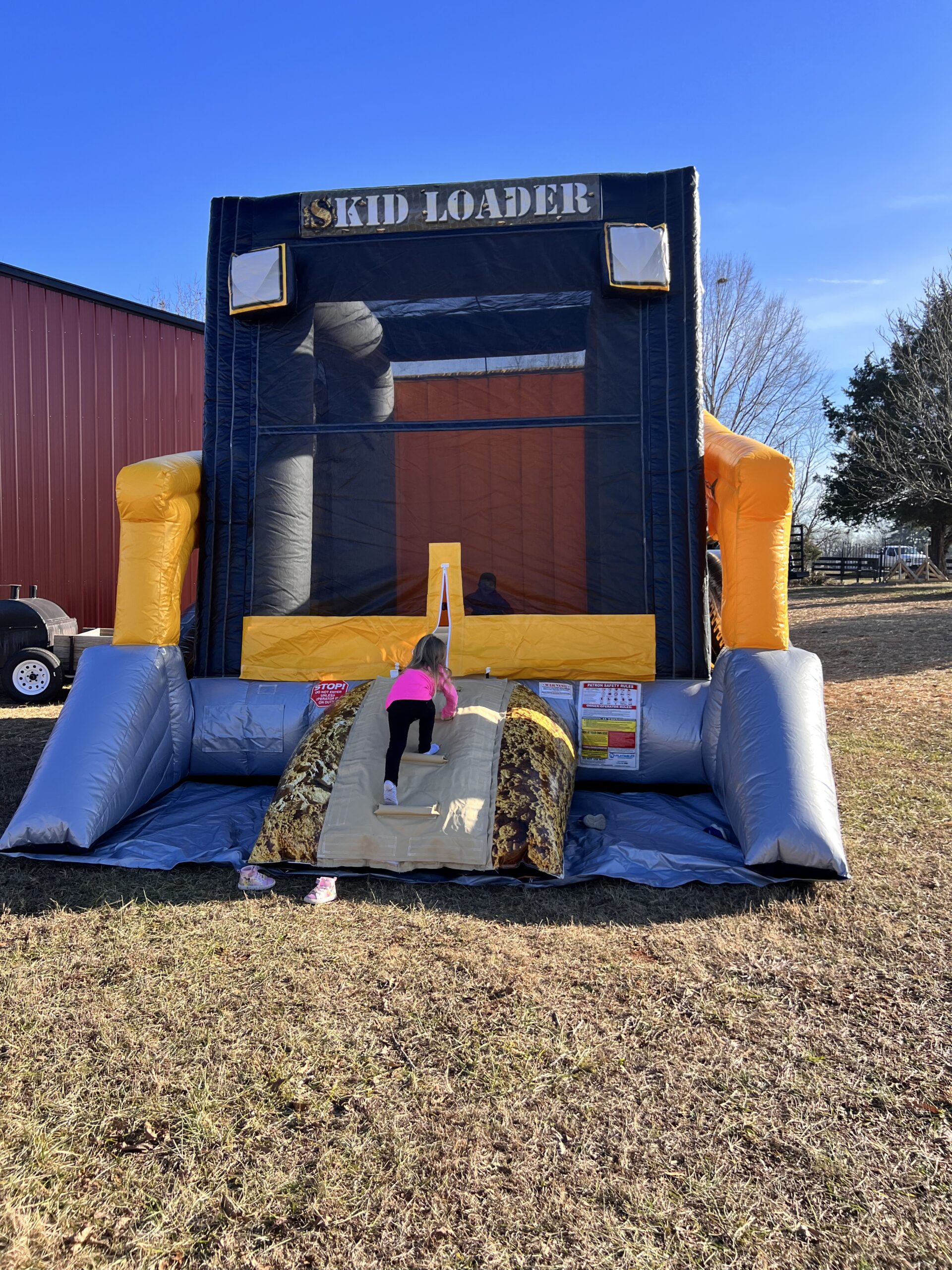 Skid loader inflatable bounce house rental for birthday parties.